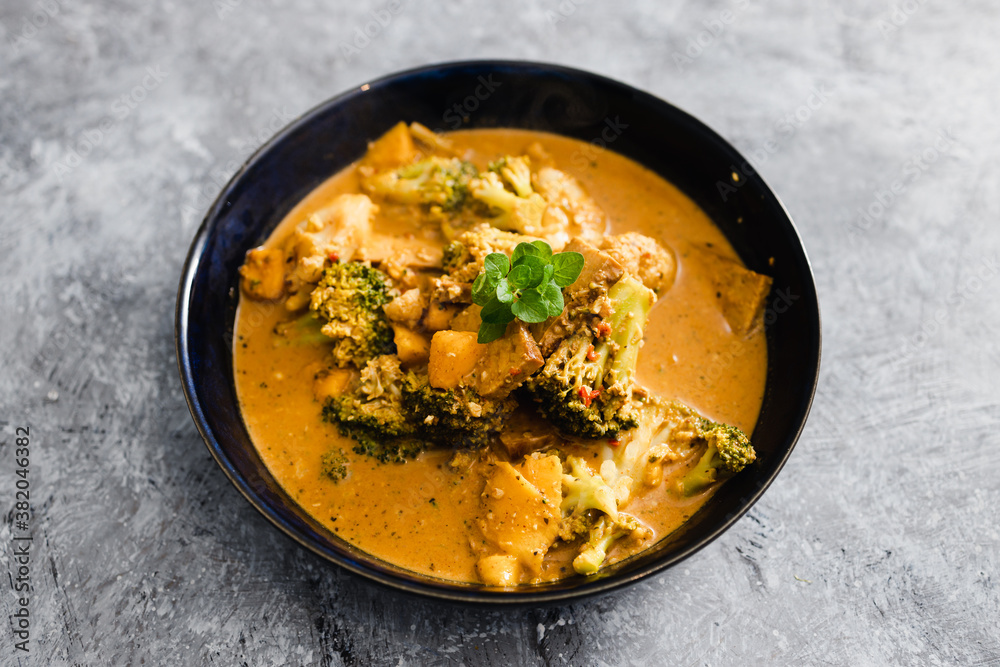 Wall mural plant-based food, vegan cauliflower mango and tempeh curry