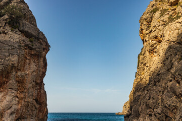 Sunny day over the rocks and the blue water in Sa Calobra, Palma de Mallorca, Balearic Islands, Spain