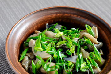 Festive salad with pickled mushrooms and green onions.