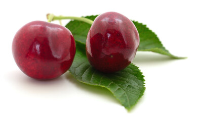 Sweet cherries with stem and leaves.