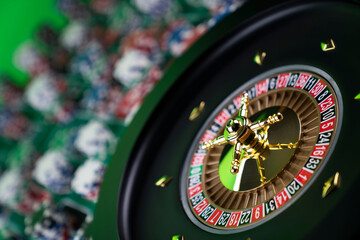 Casino theme, close up of roulette, red and black numbers. Stack of chips in the background.
