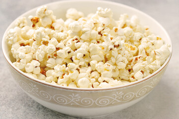 popcorn in a plate on a gray background