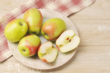whole and cut apples on a plate