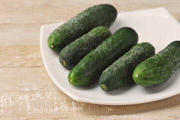 young green cucumbers on a plate