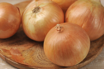 Golden onion on wooden background