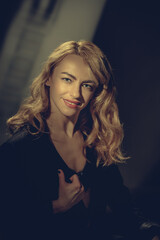 Fototapeta premium Portrait of beautiful luxurious young blonde woman posing on studio background