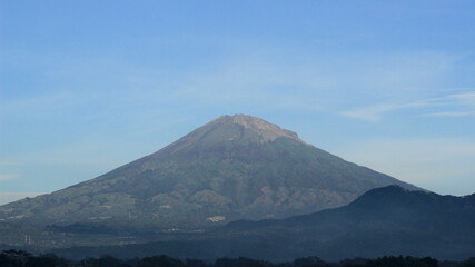 The peak of the mountain is visible in the morning when the weather at the top is sunny. A...
