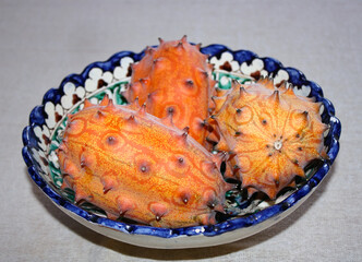 Three Mature kiwano on a painted platter.