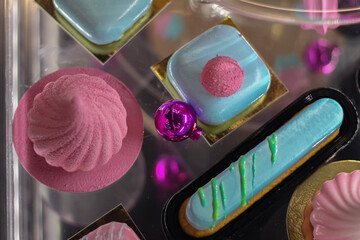 Mousse cakes and eclairs in a New Year's pastry shop window