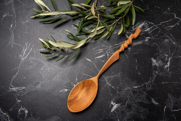 handmade wooden spoon on black marble
