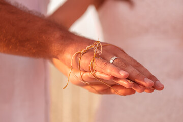 Traditional Sri Lanka wedding. The ritual  connectedness fingers newlyweds wih golden thread