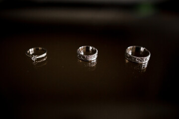 wedding rings lie on a dark table