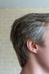 Obraz premium Young man portrait close up, gray hair at the temples.