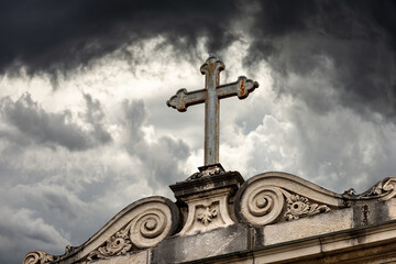 Close-up of an ancient Christian Cross on a dramatic sky, Church of San Daniele (1076-XVII century), Padua, Veneto, Italy, Europe.