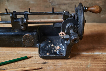Closeup of a vintage pencil sharpener. Old pencil sharpener with metal gears.