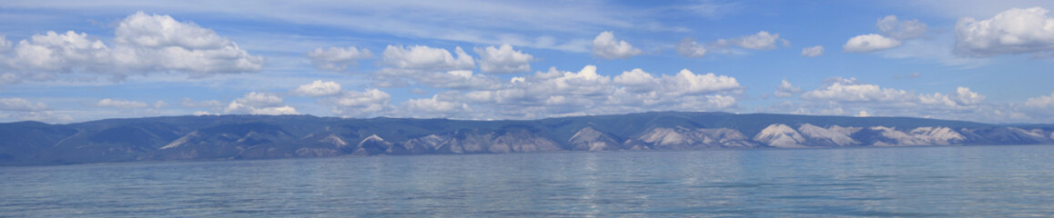 Landscape Lake Baikal, eastern Siberia, Irkutsk region, Russia. Panorama of the lake, mountains, rocks, water, sunny day with blue sky