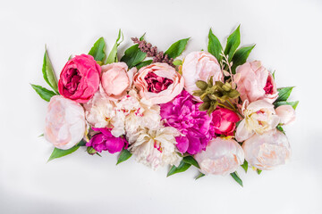 Flat lay of flowers and green leaves