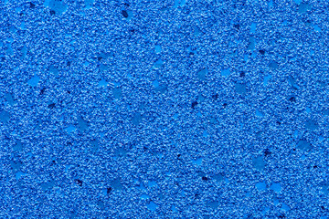 Fototapeta na wymiar Abstract blue background with textured small particles, pebbles and glitter.