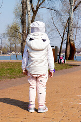 little girl walking down the street
