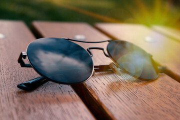 sun glasses on a wooden background,