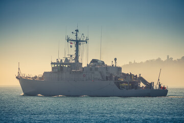 Obraz premium Patrol boat and sea port Varna, Bulgaria. Industrial cranes, ships and boats on the harbour
