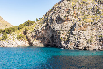 Fototapeta na wymiar Sunny day over the rocks and the blue water in Sa Calobra, Palma de Mallorca, Balearic Islands, Spain