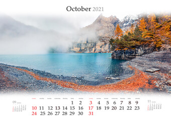 Calendar October 2021, B3 size. Set of calendars with amazing landscapes. Thick fog gloving mountain peaks and lake. Calm autumn view of unique Oeschinensee Lake, Switzerland, Europe.