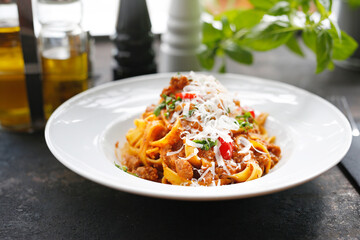 Tagliatelle with tomato sauce, traditional Italian cuisine. Appetizing dish served on a white plate. culinary photography.