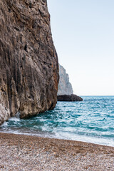 Fototapeta na wymiar Sunny day over the rocks and the blue water in Sa Calobra, Palma de Mallorca, Balearic Islands, Spain