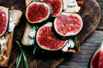 Toast with cream cheese, figs and honey on the table