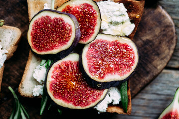Toast with cream cheese, figs and honey on the table