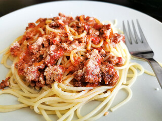 Spaghetti Bolognese with minced beef, onion, chopped tomato, garlic, olive oil, stock cube, tomato puree and Italian herb. Traditional Italian food.