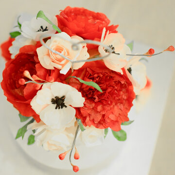 Wedding Cake Of Fondant Flowers Ice Peak Peony With Red Flower Buds On White Background From Above