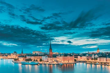 Foto op Aluminium Stockholm, Sweden. Scenic View Of Stockholm Skyline At Summer Evening. Famous Popular Destination Scenic Place In Dusk Lights. Riddarholm Church In Night Lighting © Grigory Bruev