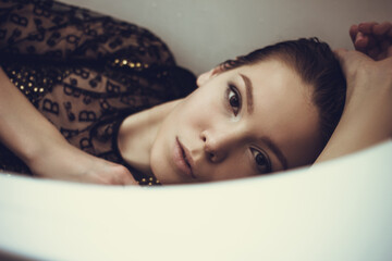 Female high fashion concept. Beautiful fashionable woman posing in bath