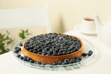 Concept of tasty breakfast with blueberry pie on white table