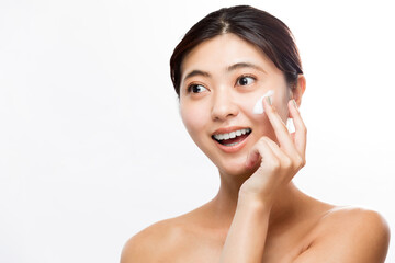 顔にクリームを塗る女性