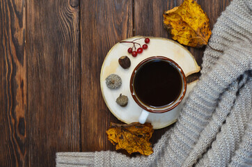 warming autumn drink a cup of coffee, a warm sweater, autumn decor with copy space