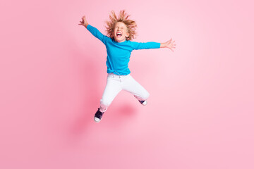 Full length photo of little child jump close eyes open mouth wear blue turtleneck trousers sneakers...