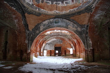 abandoned red brick church in winter