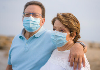 pensioner woman and her husband taking romantic walk together - happy retired mature couple in face...