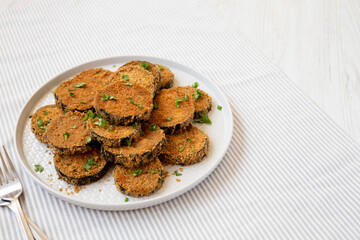Homemade Garlic Parmesan Baked Eggplant on a plate, side view. Copy space.