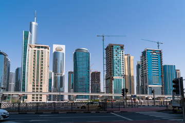 Fototapeta na wymiar Residential towers and villas of Dubai Marina, UAE at a sunny day. Futuristic cityscape Skyscrapers of the capital of the Emirate of Dubai. A center for regional and international trade.