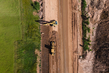 Road construction site with machinery working.