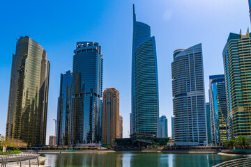 Fototapeta na wymiar Panoramic view of skyscrapers of downtown of Dubai, UAE at a sunny day. Modern cityscape of the capital of the Emirate of Dubai. A center of new technologies in business of Western Asia