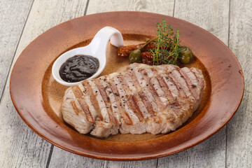 Grilled pork steak with pepper sauce