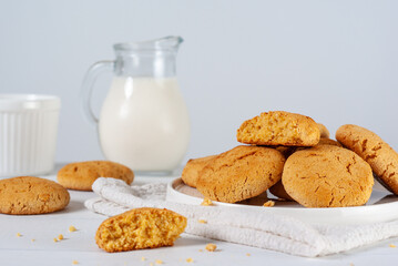 Homemade golden brown corn biscuits on a white background with selective focus