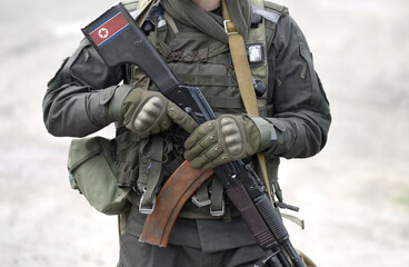 Flag of North Korea on assault rifle butt. Collage.