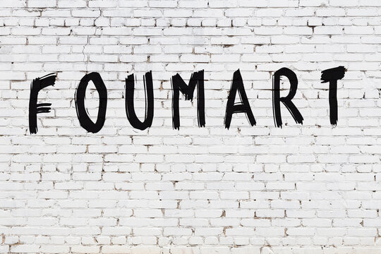White wall with black paint inscription foumart on it