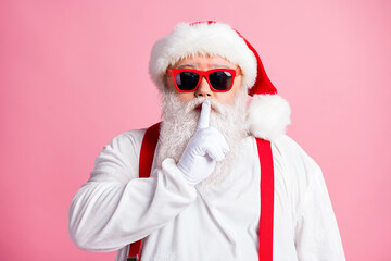 Serious santa claus dont want x-mas christmas advent gift present delivery confidential plan fail put finger lips ask not say wear trendy headwear gloves overalls isolated pastel color background